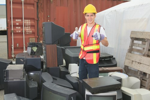 Office clearance team removing desks and chairs from a London office