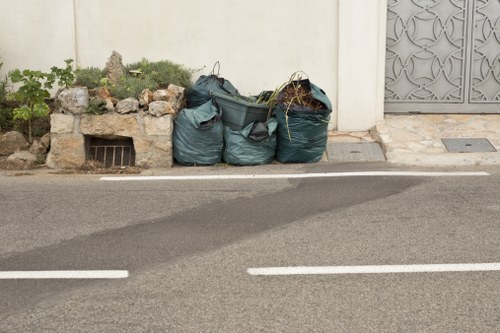 Person reporting a rubbish collection problem with bins at the curb